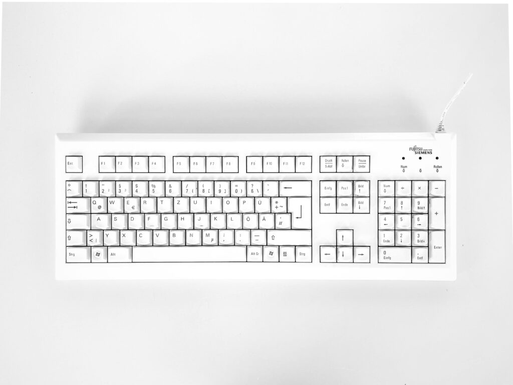 White mechanical keyboard displayed against a white background, emphasizing minimalist design.